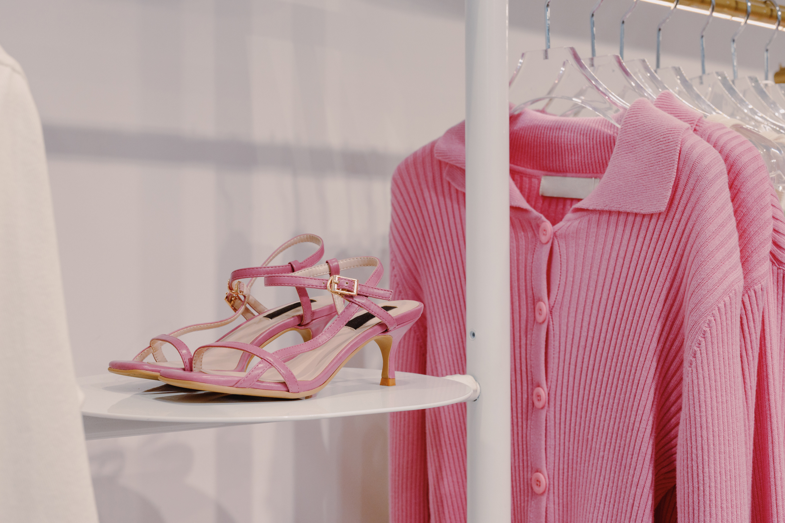 Pink Sandals Beside a Pink Cardigan 